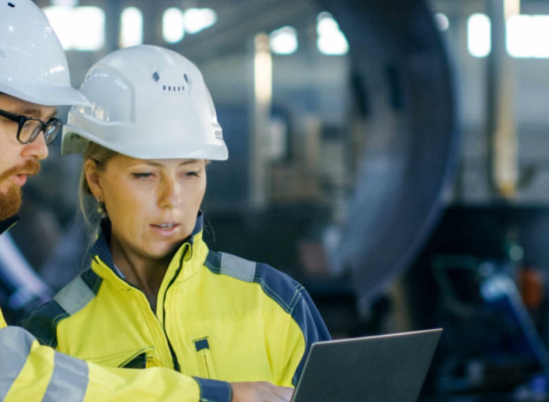 Operator in a white hard hat at a plant