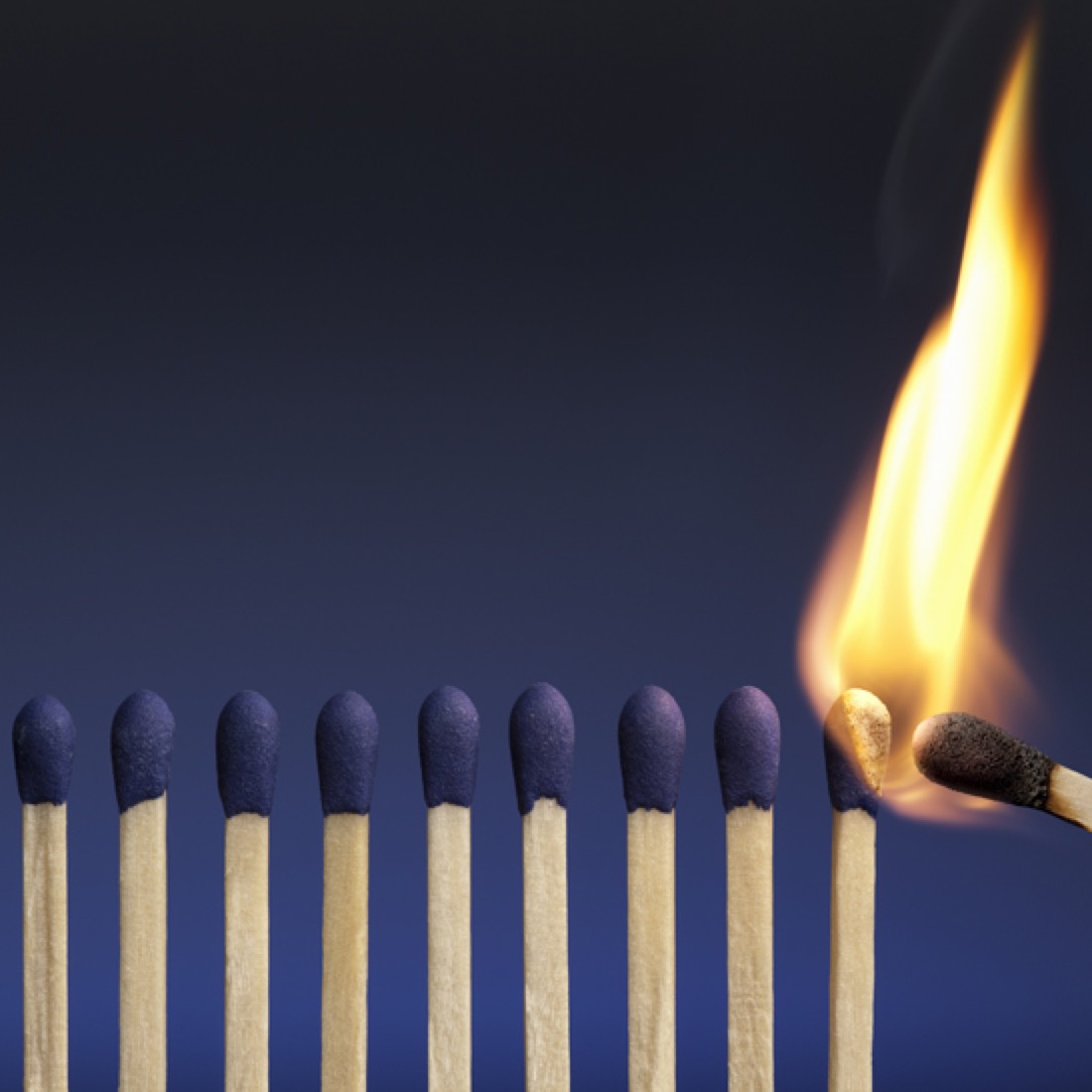 Row of matches with the first one burning
