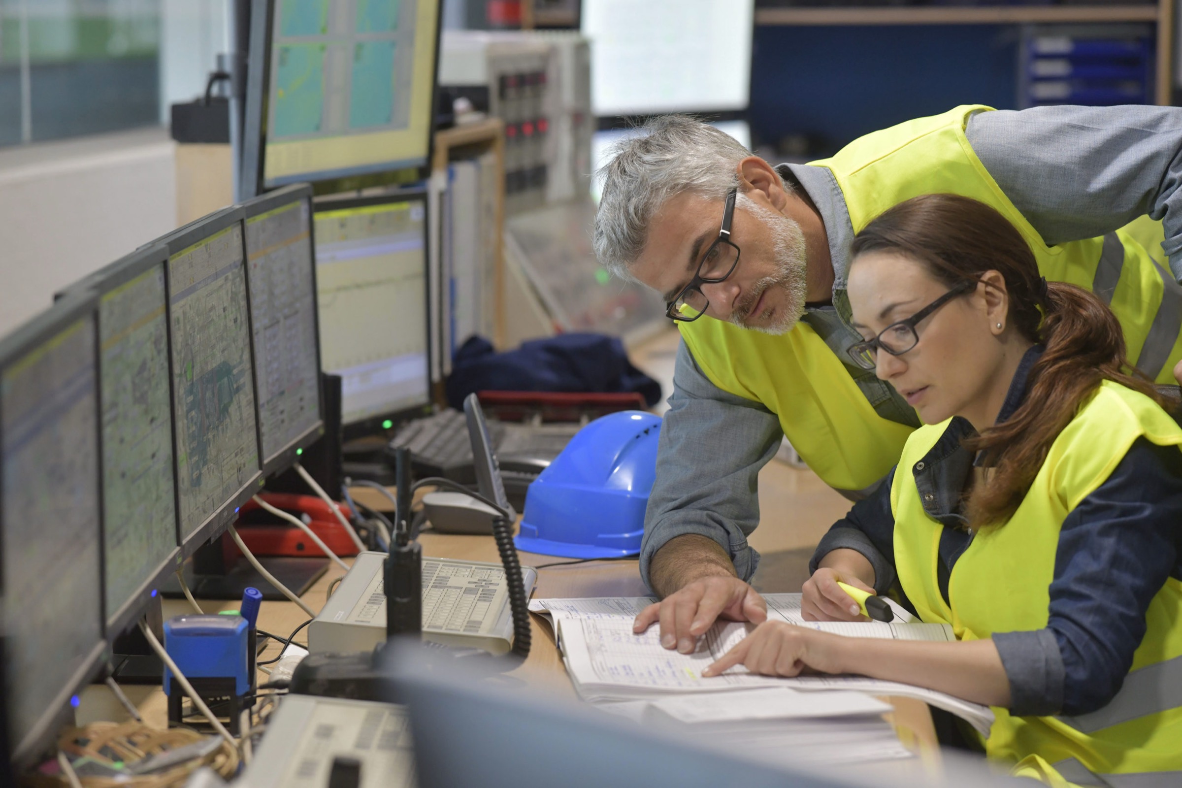 Trainer and operator reviewing a procedure in a control room