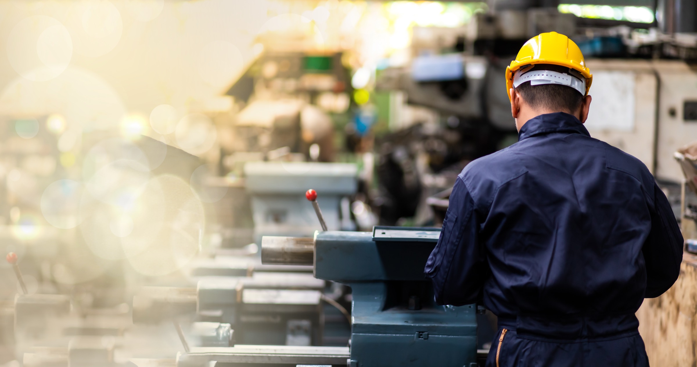 Operator in a hard hat working at plant equipment